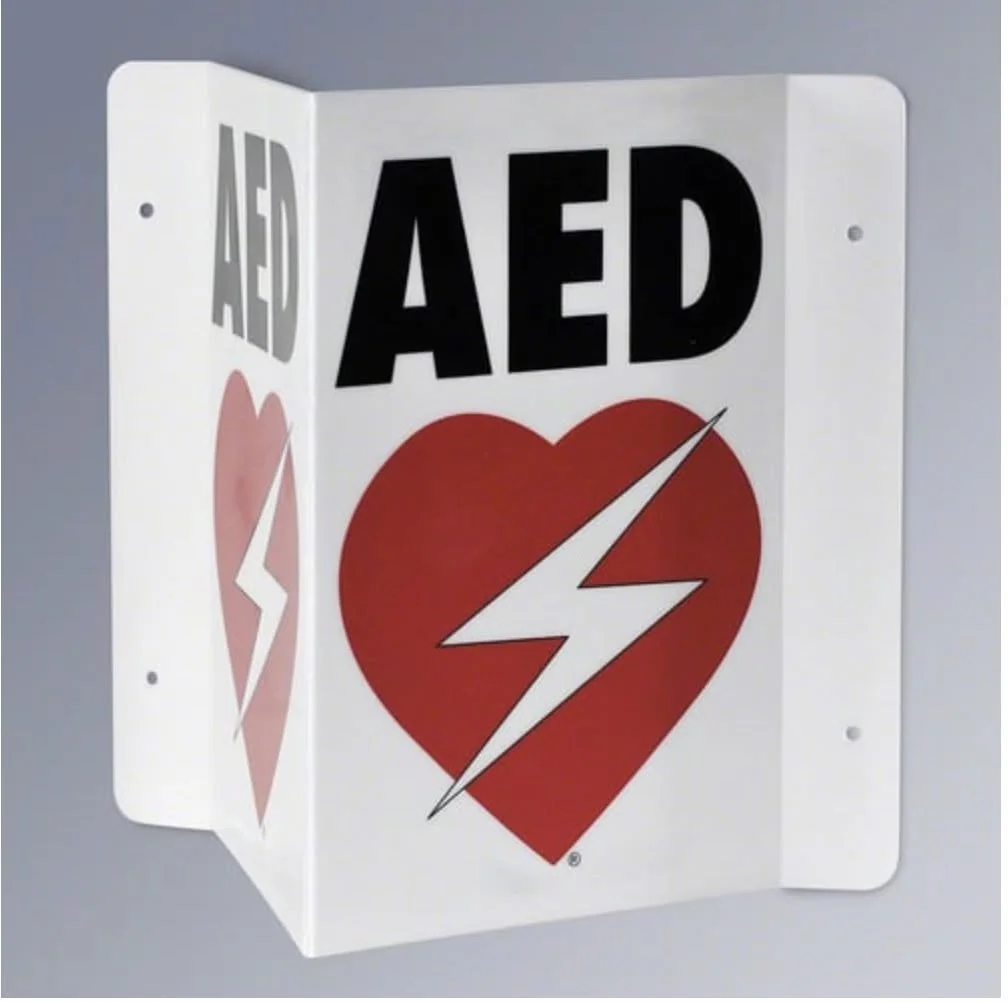 AED location sign with a heart and lightning-bolt symbol.