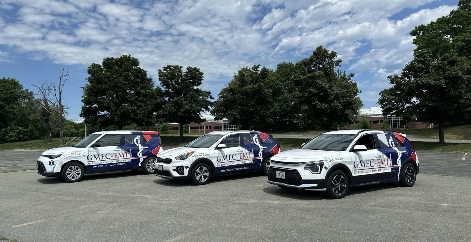Three GMEC-EMT branded training vehicles.