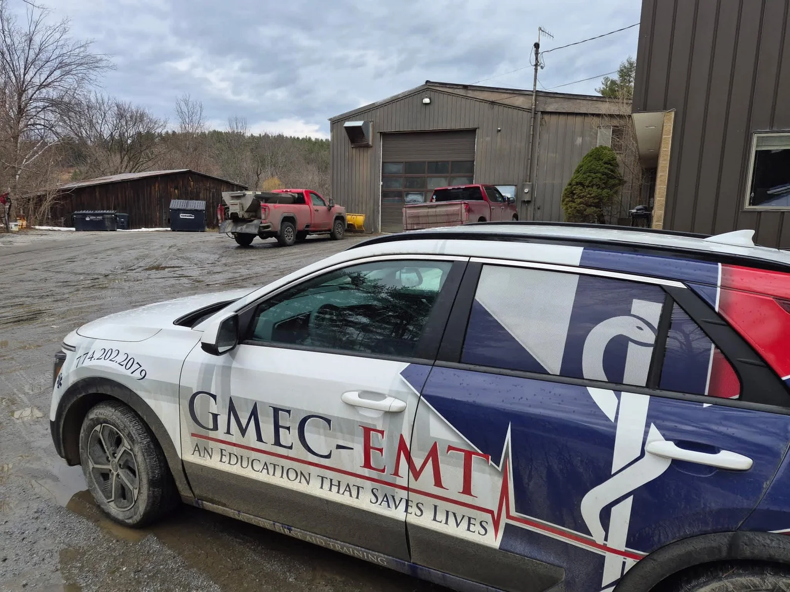 GMEC-EMT branded training vehicle at a workplace.