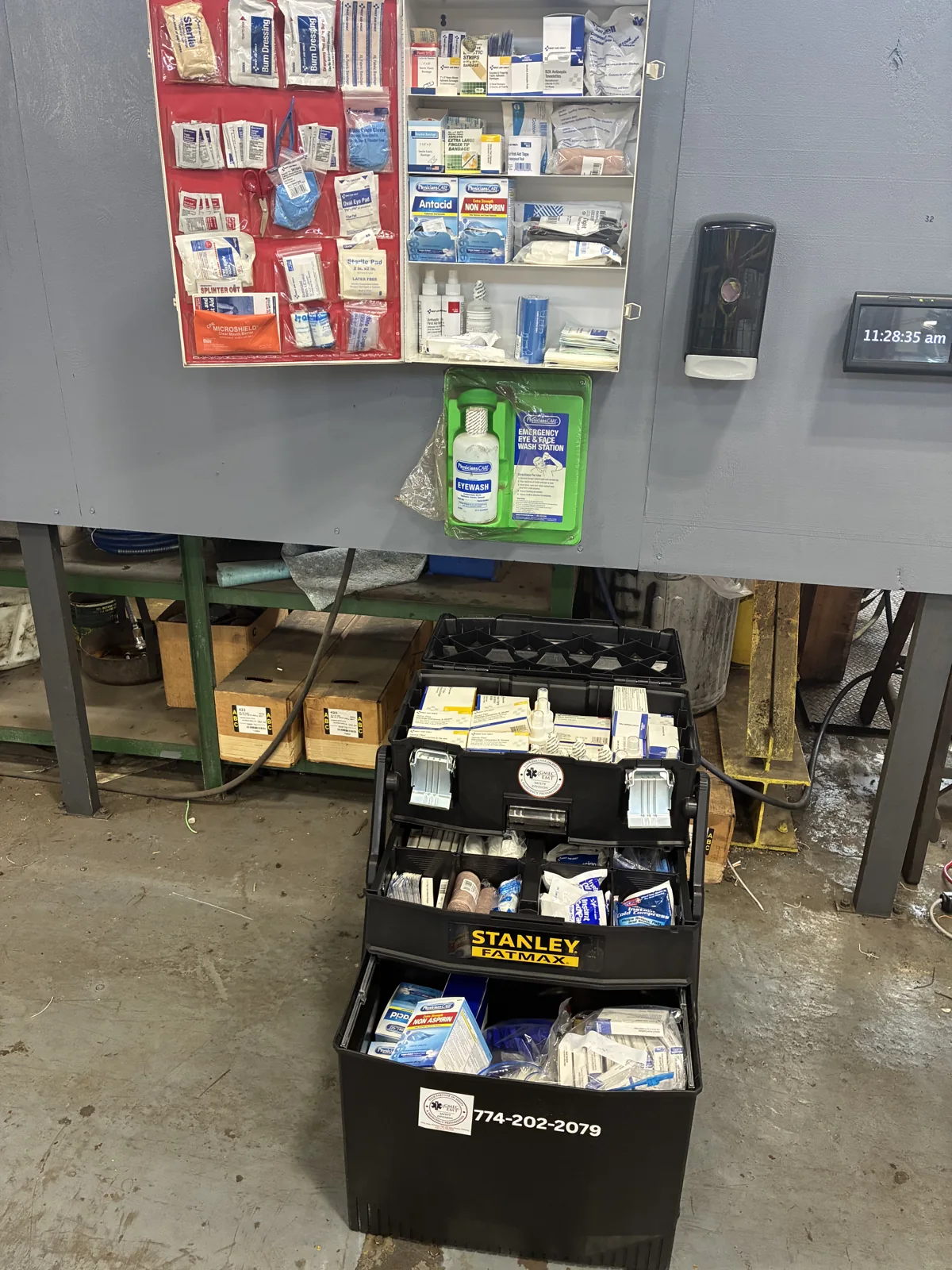 GMEC workplace safety supplies with a stocked wall cabinet and portable equipment case.